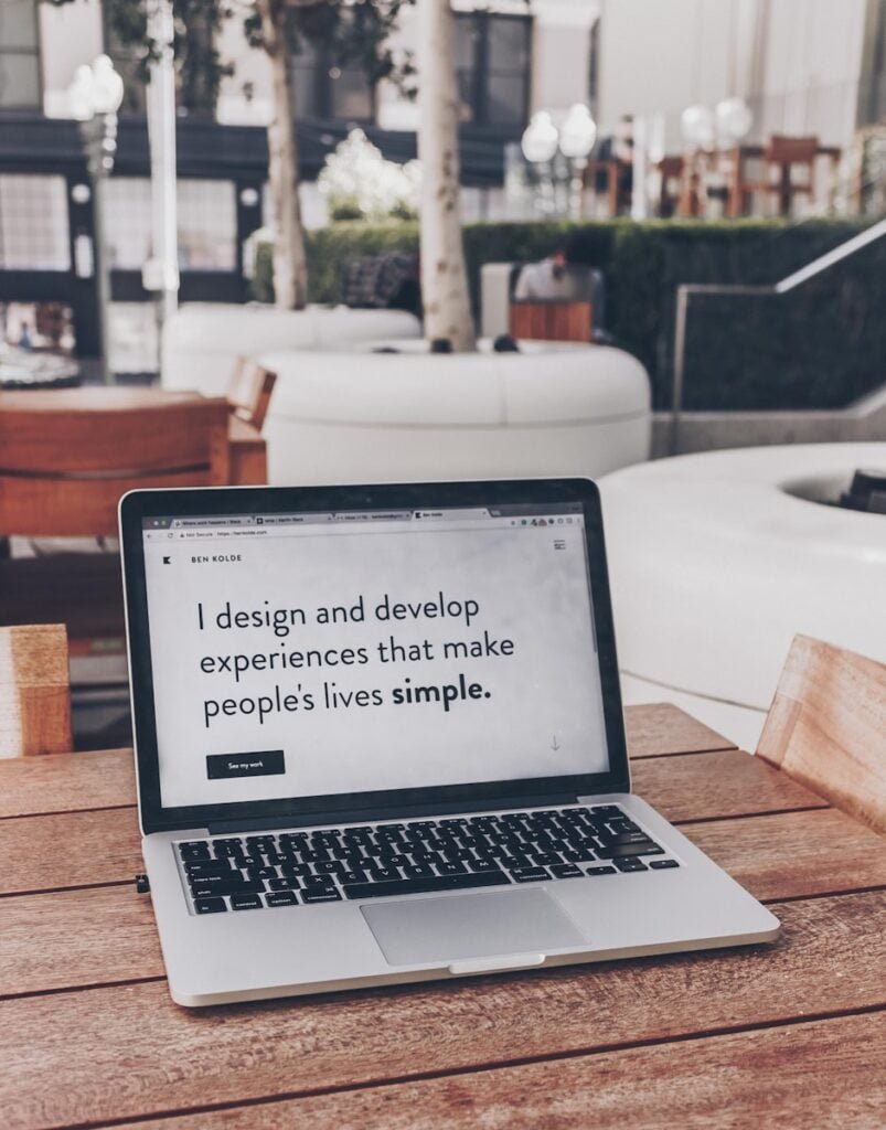 Black and white laptop on a wooden desk, perfect for small business web design.