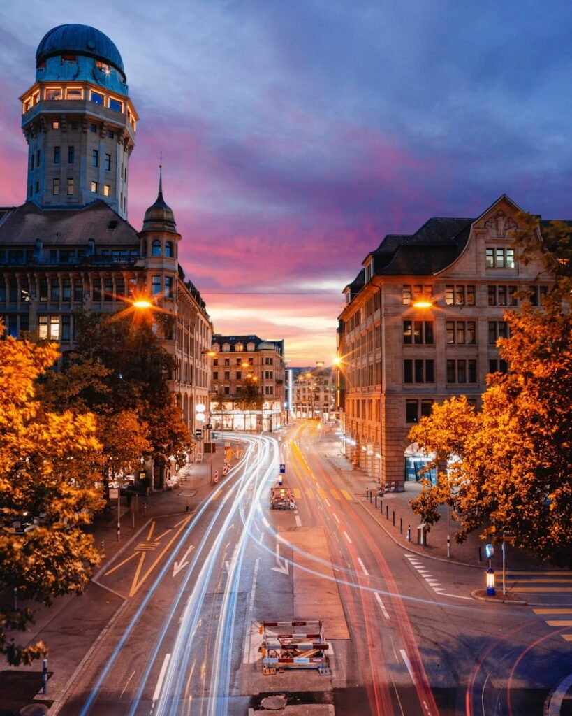 timelapse photo of cars passing by building in Zurich a Swiss business capital